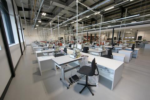 Room full of empty workstations at Boohoo model factory, Leicester